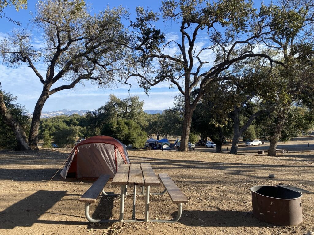 Cachuma Lake Recreation Area - campsite set up with a tent, picnic table, and firepit 