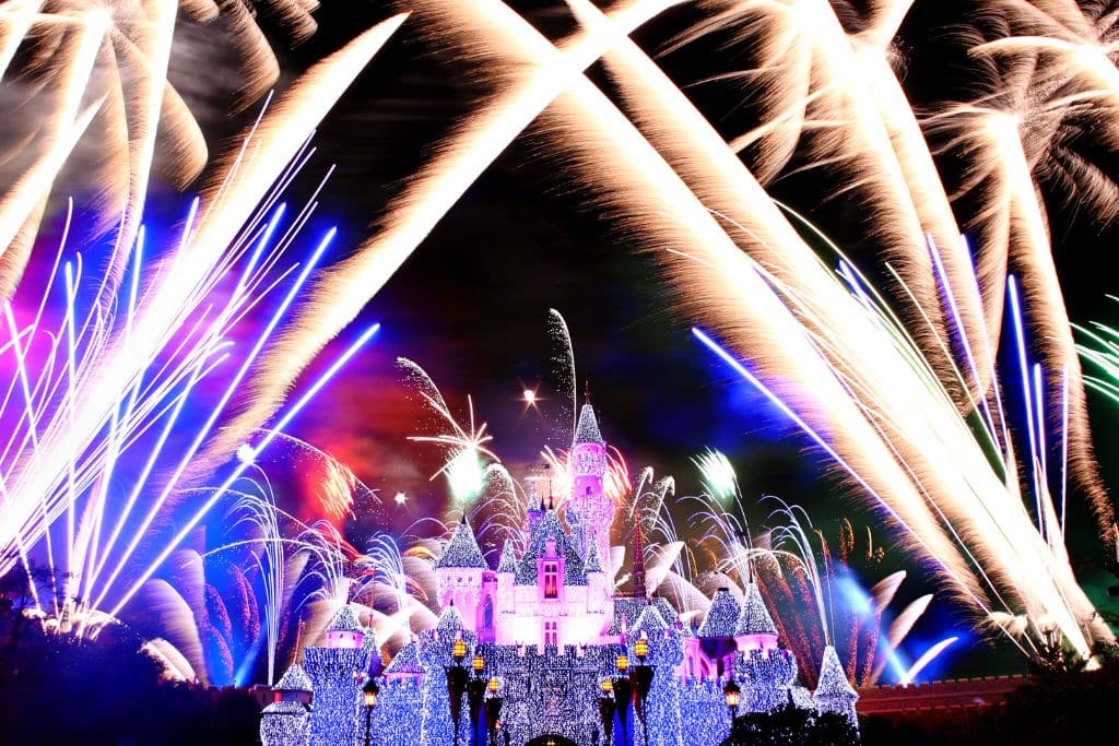 fireworks at Disneyland across Sleeping Beauty Castle, decorated for Christmas