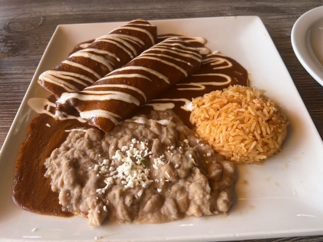 Chicken Mole Enchiladas with beans and rice from El Capricho Restaurant and Cantina in Santa Paula, California