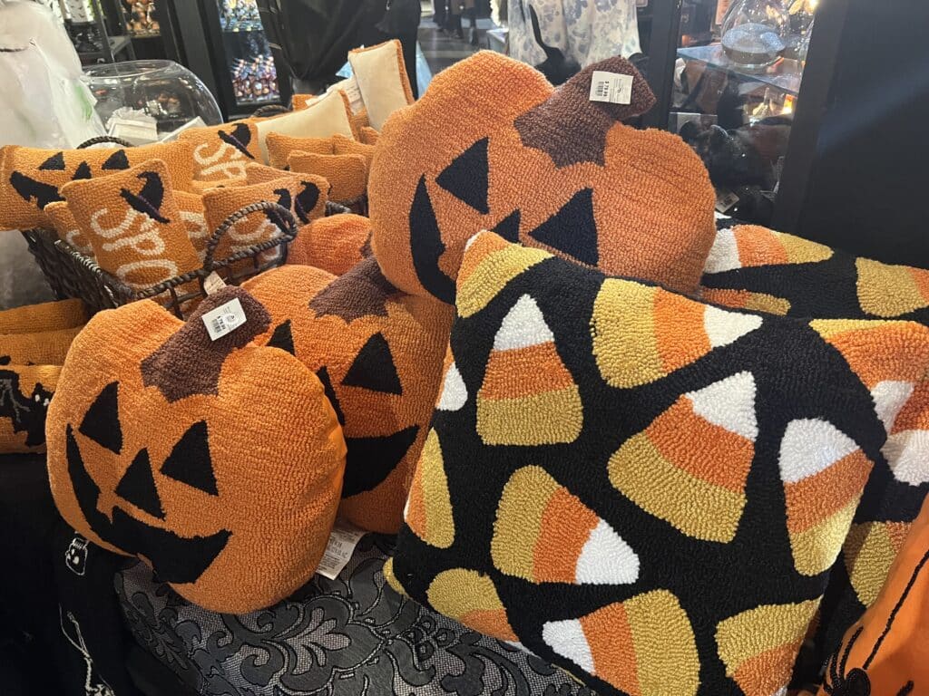 Halloween themed throw pillows with candy corn and jack o lanterns
