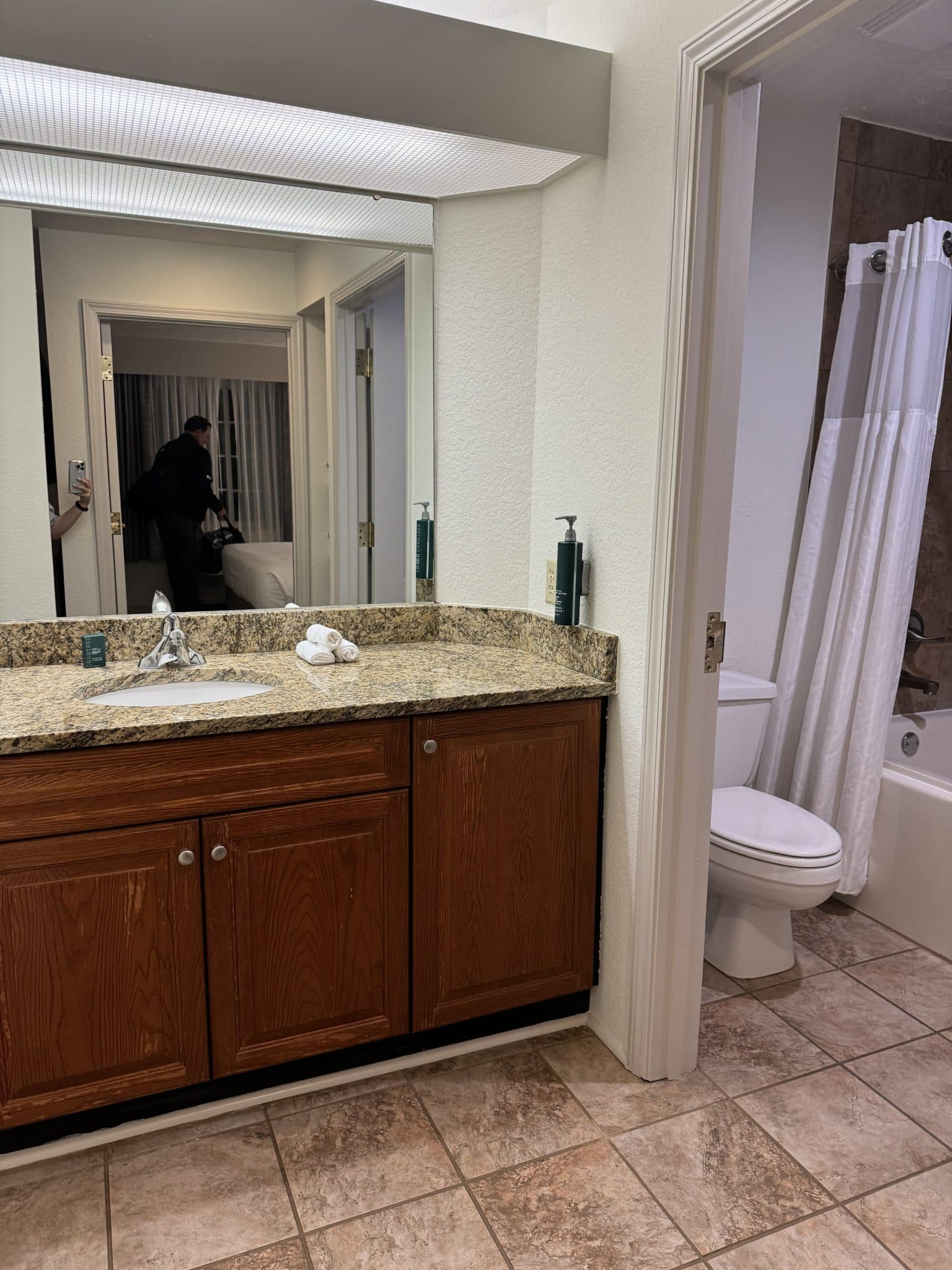 vanity outside of the bathroom with a sink and mirror