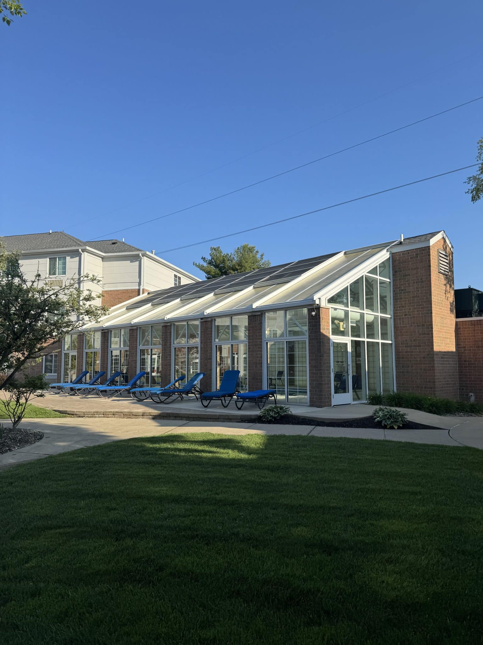 pool enclosed in a greenhouse type of building