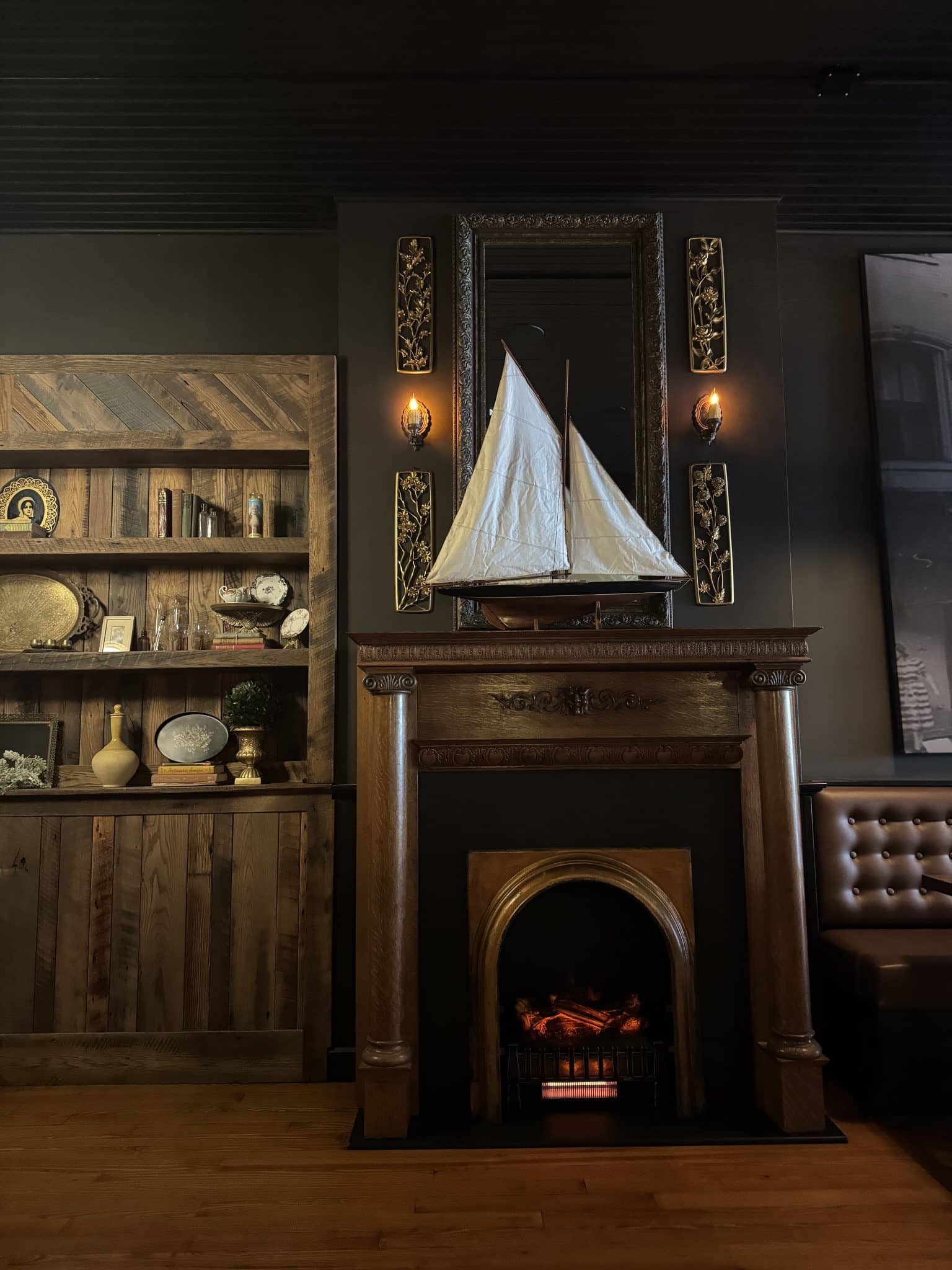 dark academia themed fireplace and bookshelf