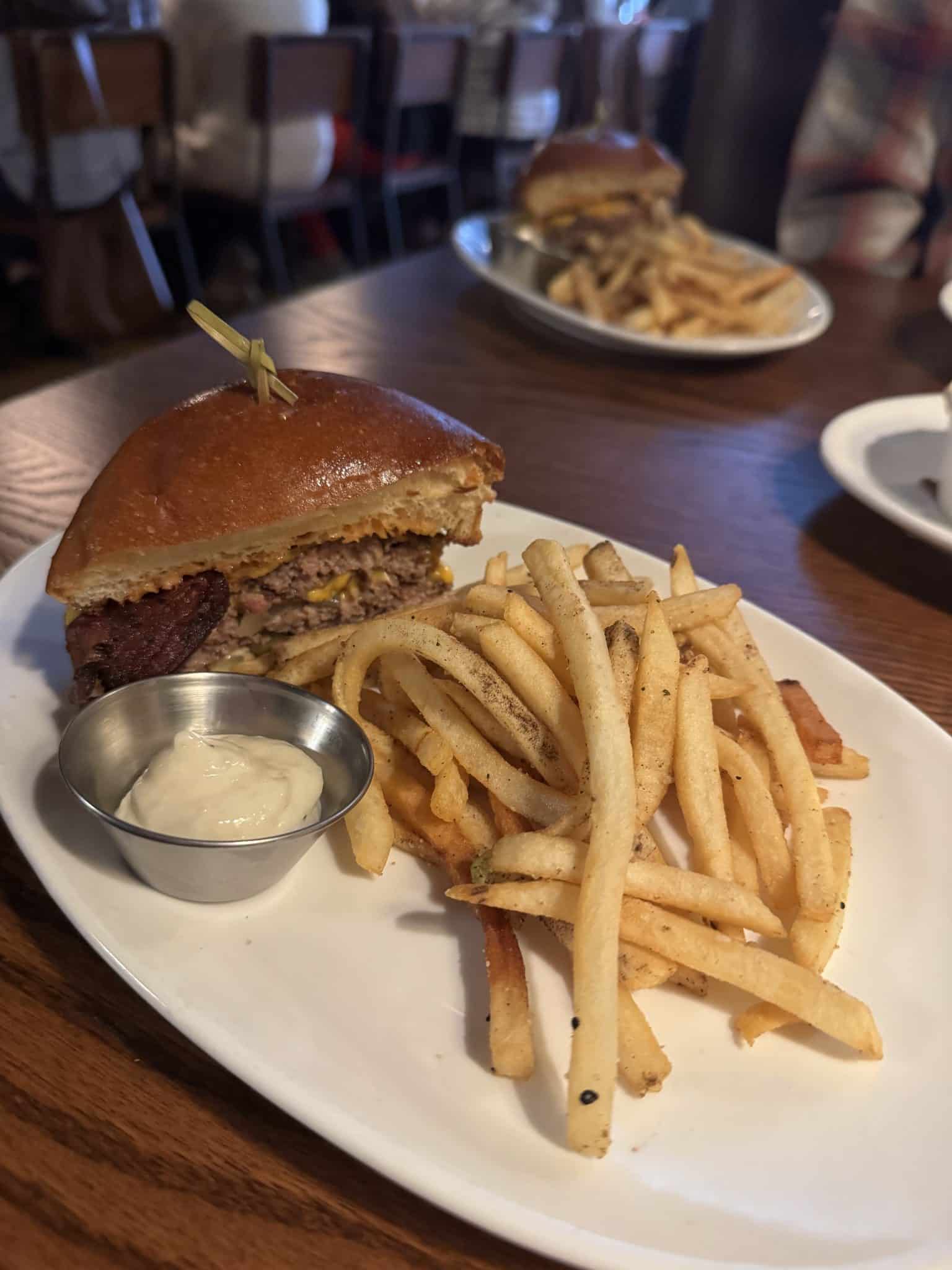 smash burger with bacon and cheese and fries